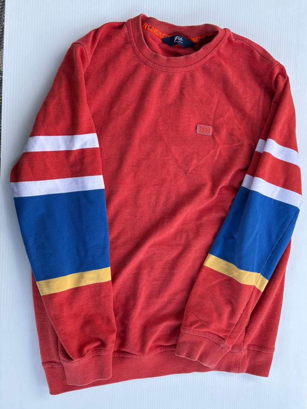 Peter England Red Crewneck Sweater with Blue, White and Yellow Sleeve Stripes